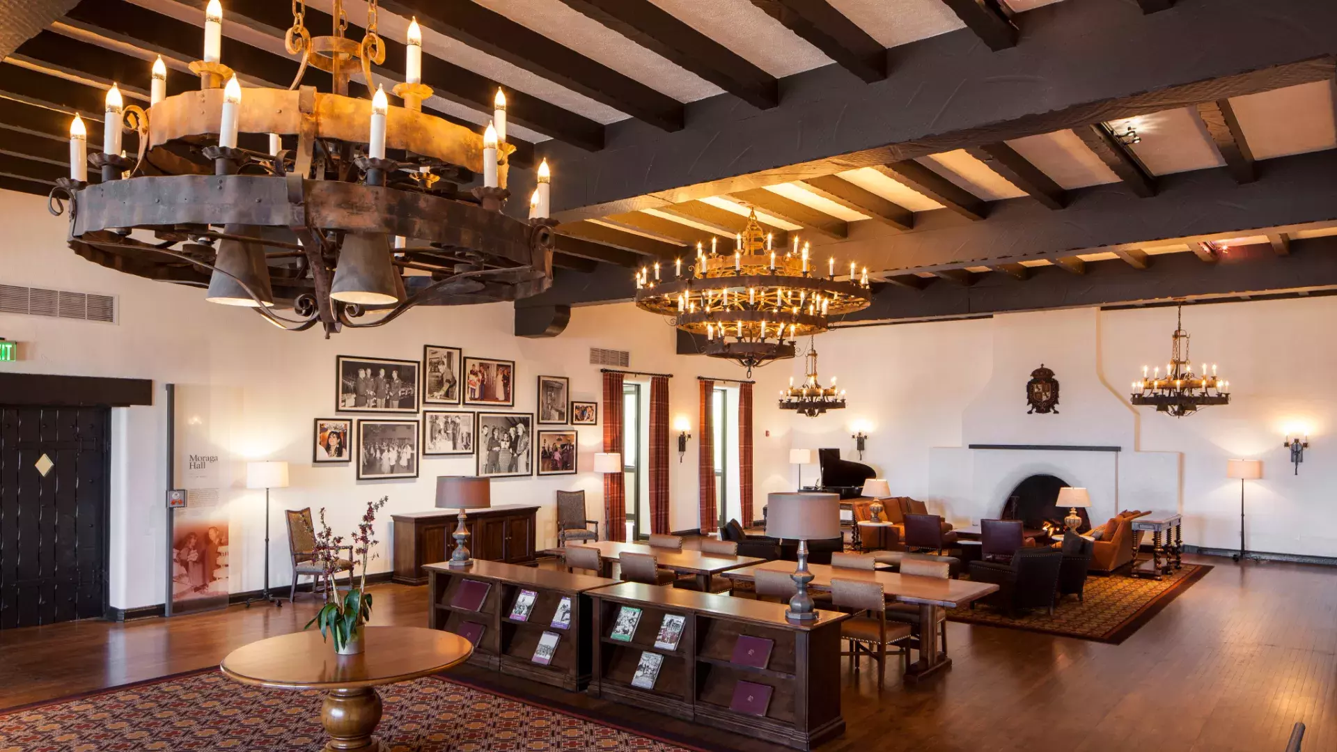 Interior of the historic Presidio Officers' Club, with wood-beam ceilings and large chandeliers.