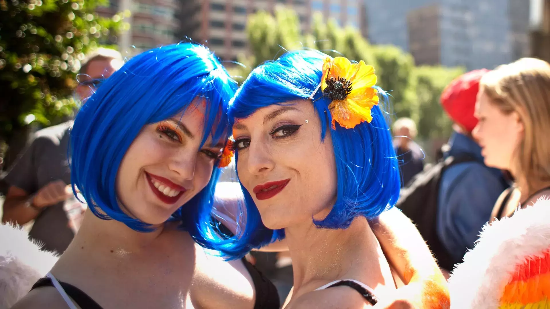 Two women sporting blue wigs attend San Francisco Pride.