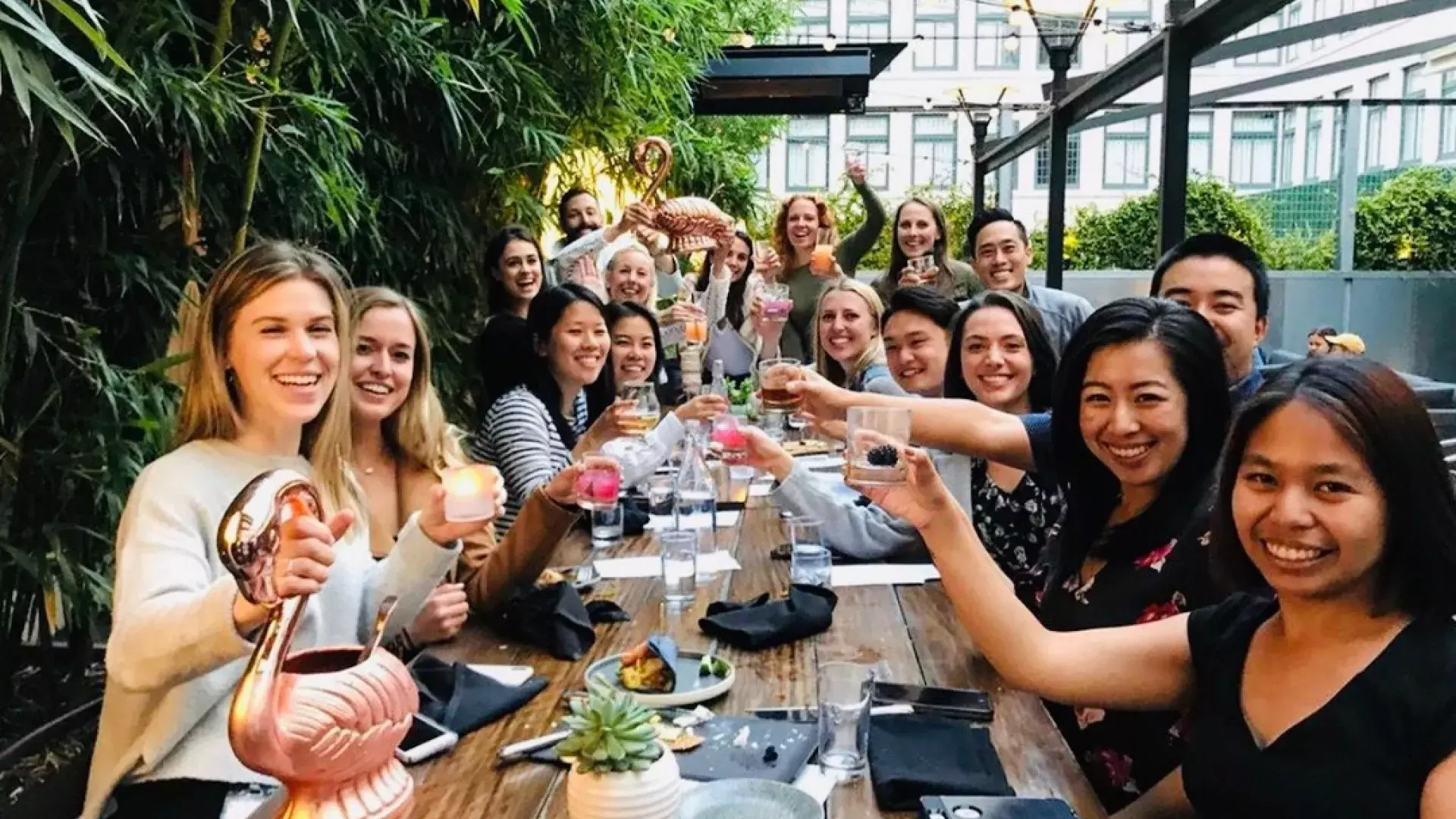 A group of people toasting at Dirty Habit