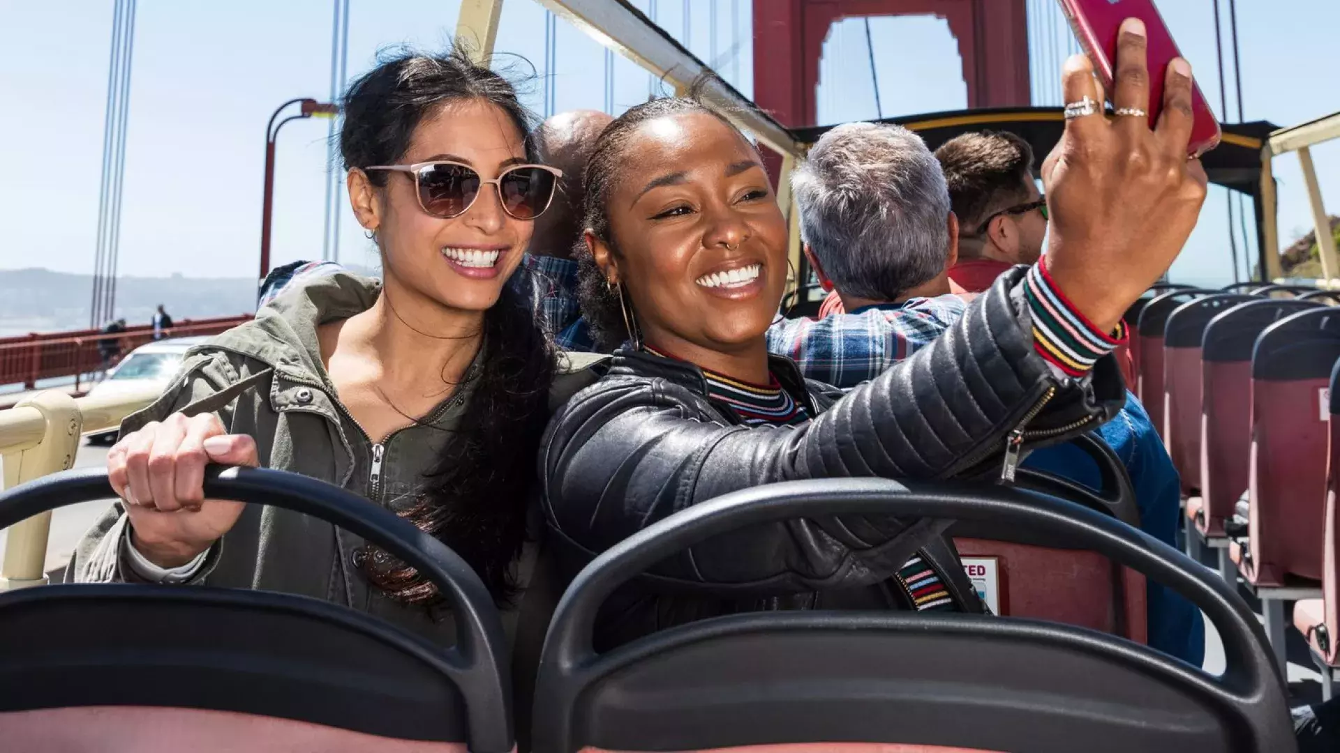 Friends taking selfies on the Golden Gate Bridge