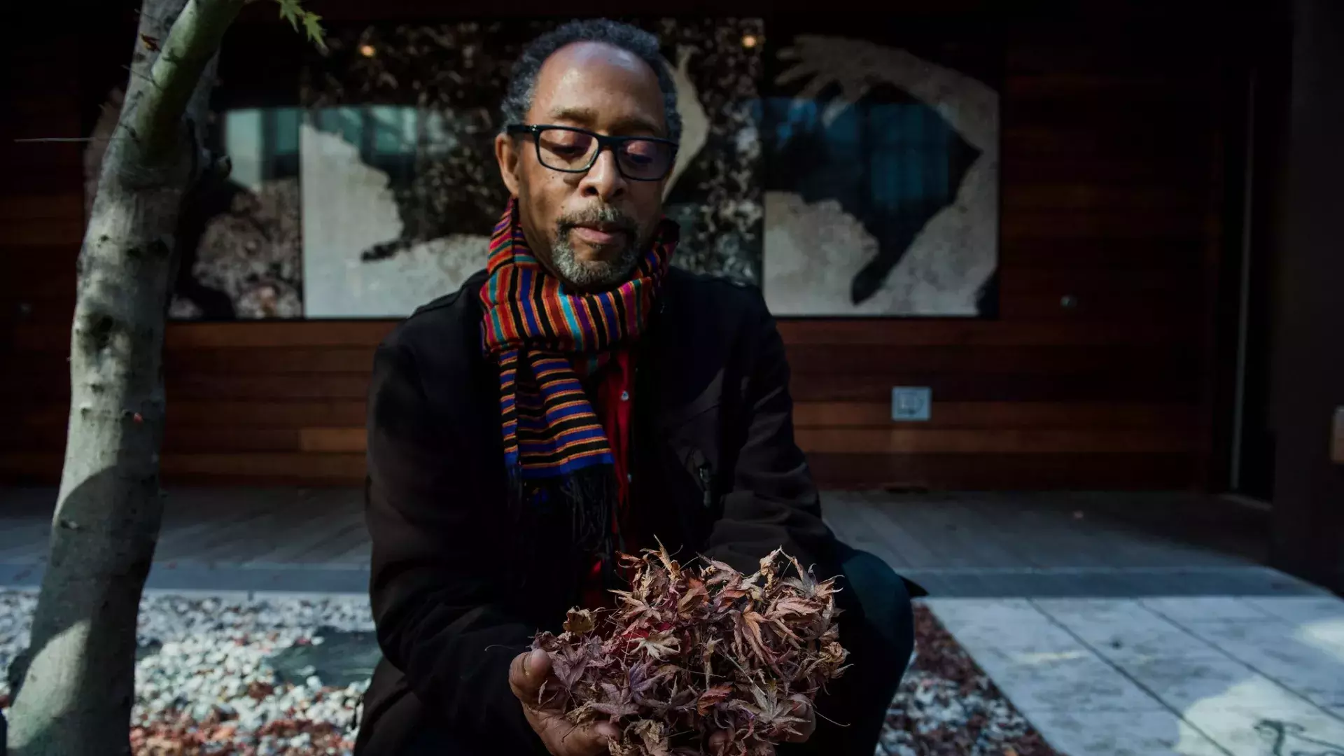 Ron Moultrie Saunders holding leaves.