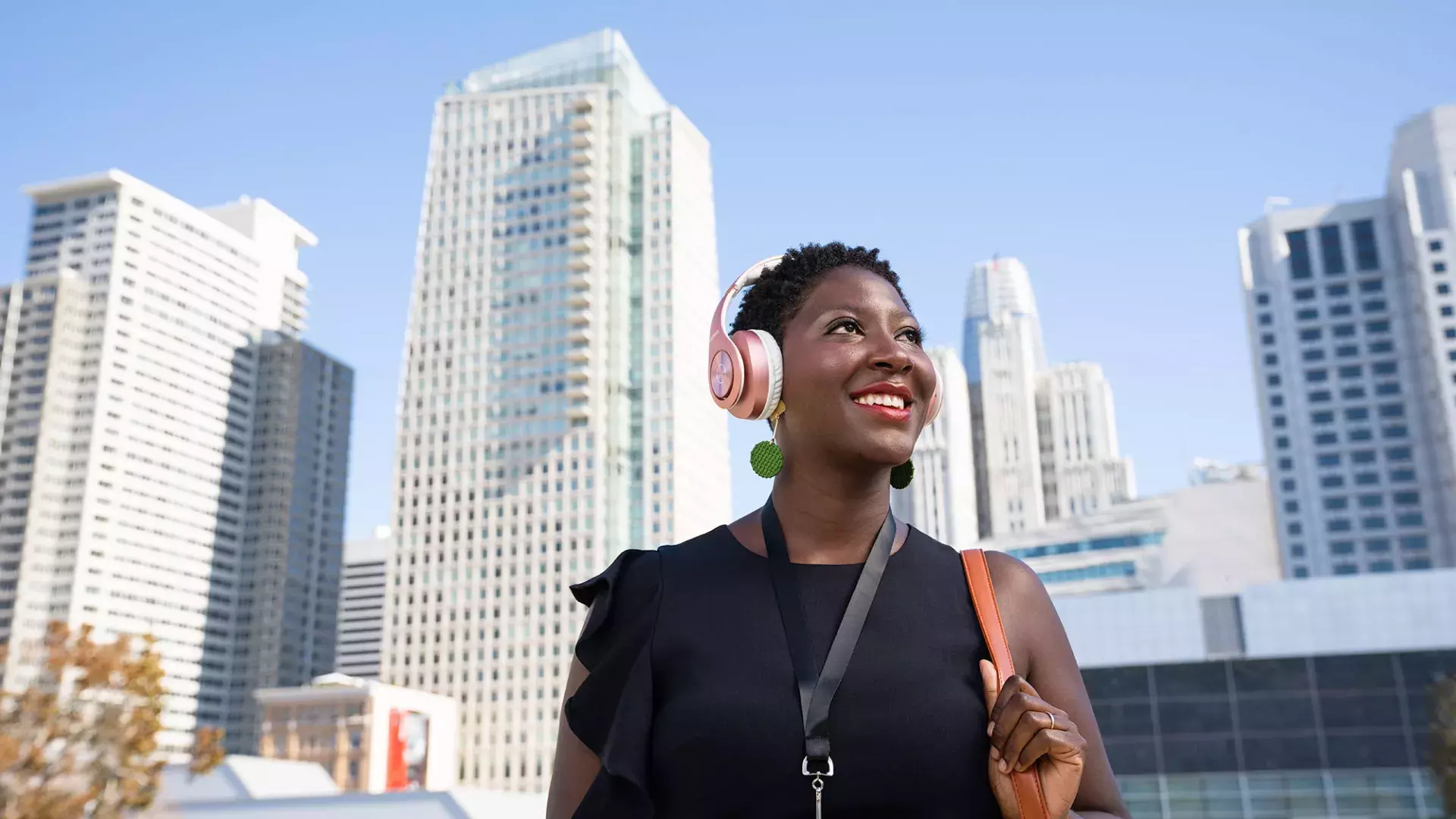 A woman wearing headphones walks through San Francisco's SoMa neighborhood.