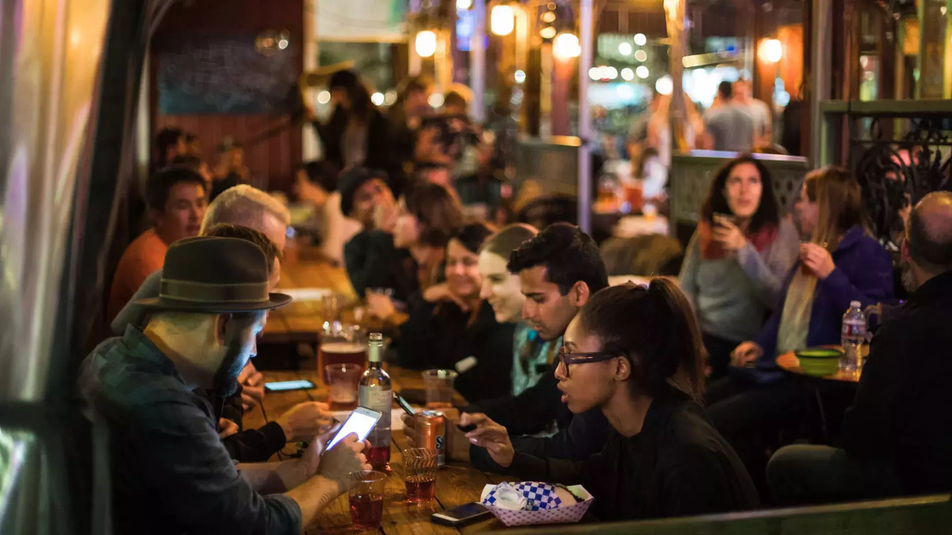 People eating in a crowded dining area in SoMa. San Francisco, California.