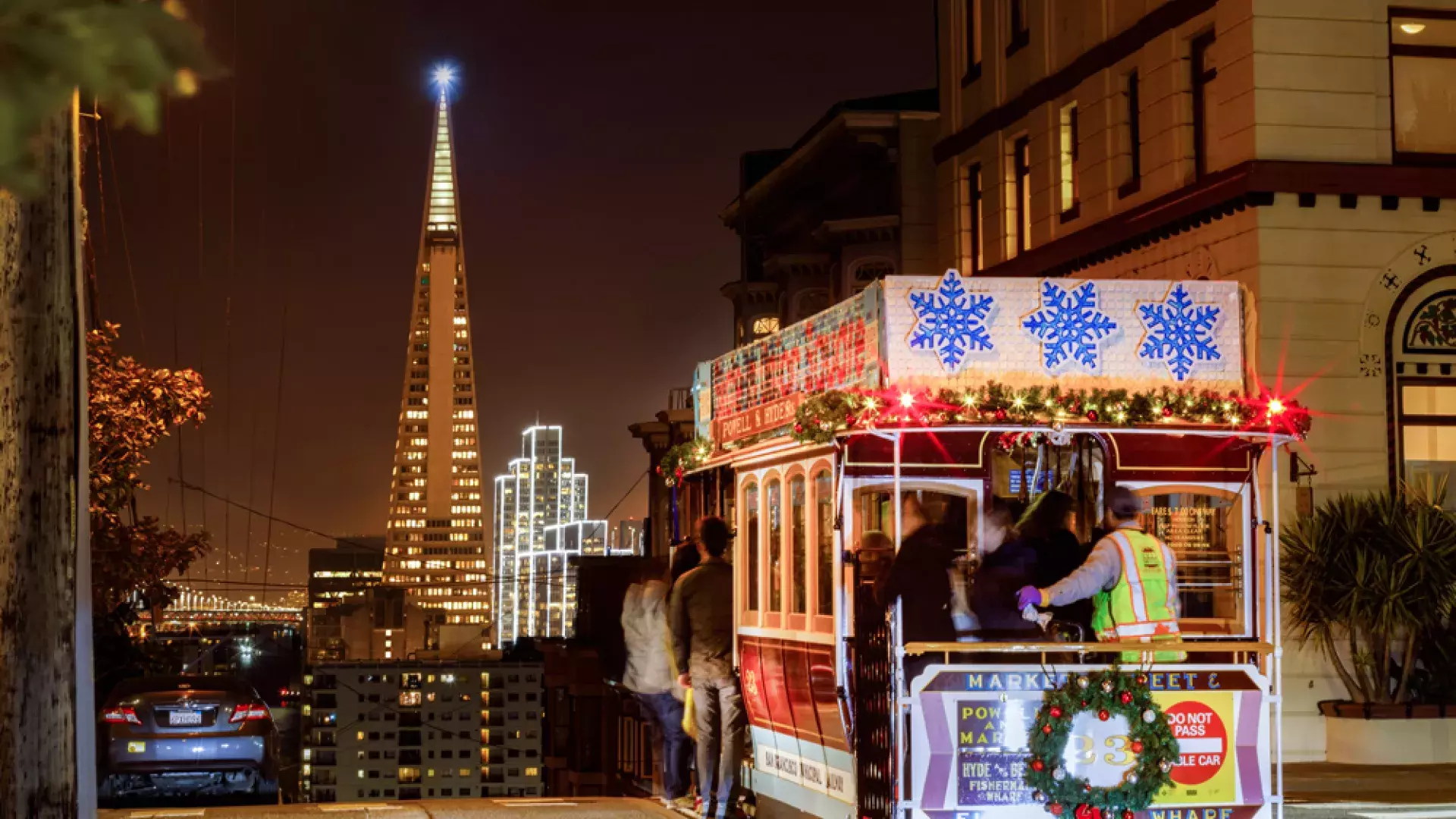 The cable cars are decorated for the holidays.