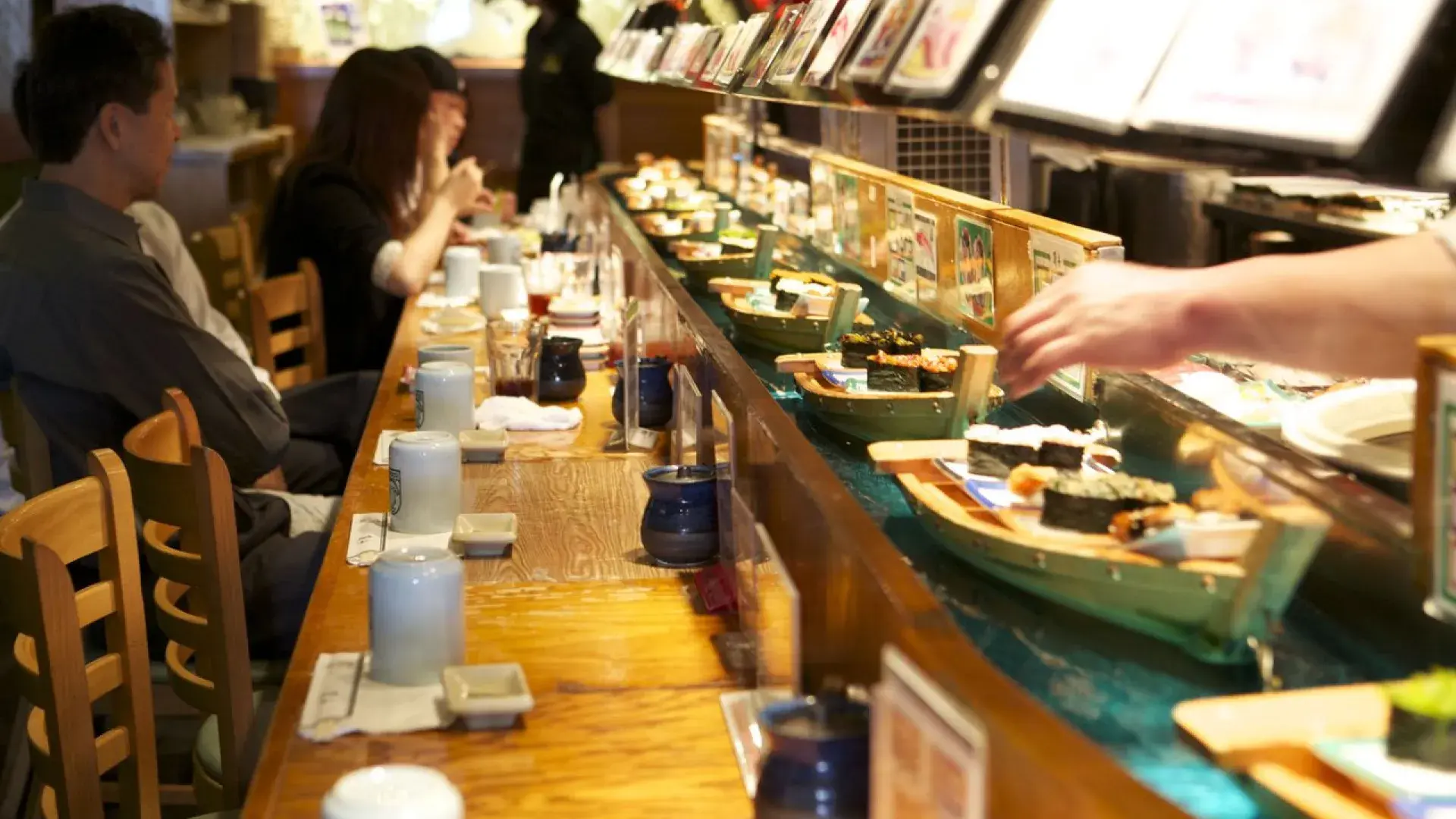 Image of sushi going by on mini-boats