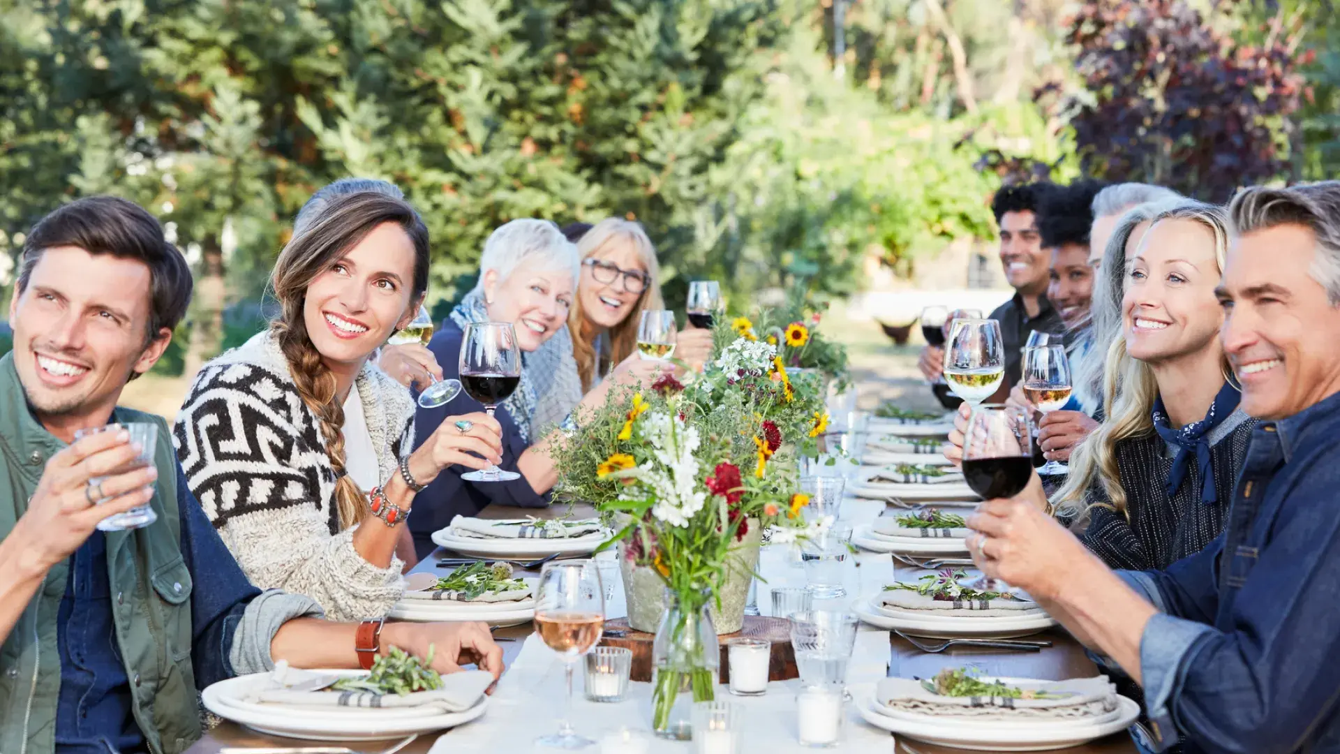 Friends at a table sharing an outdoor wine tasting