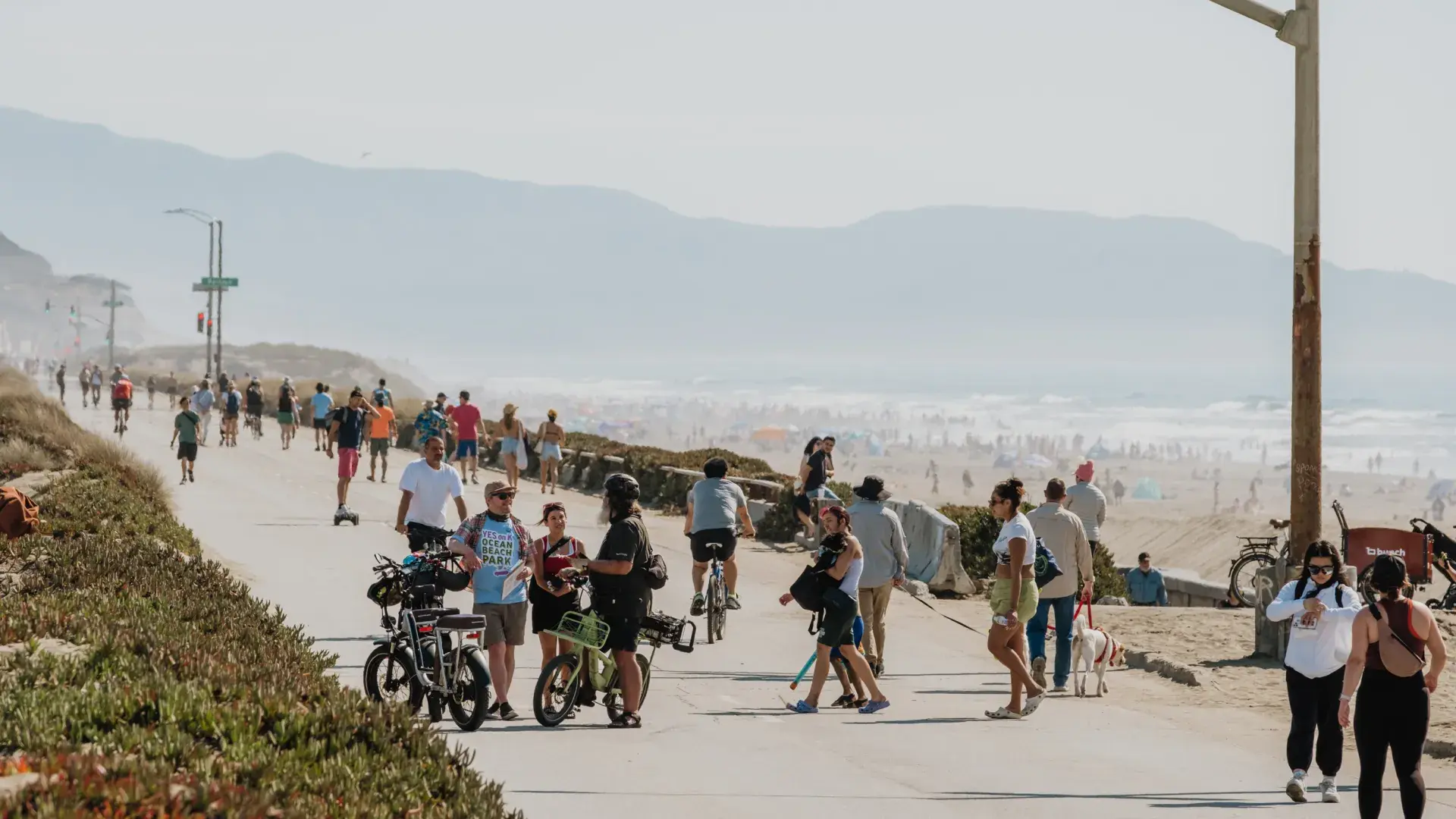 Visitors explore Sunset Dunes on a bright, sunny day.