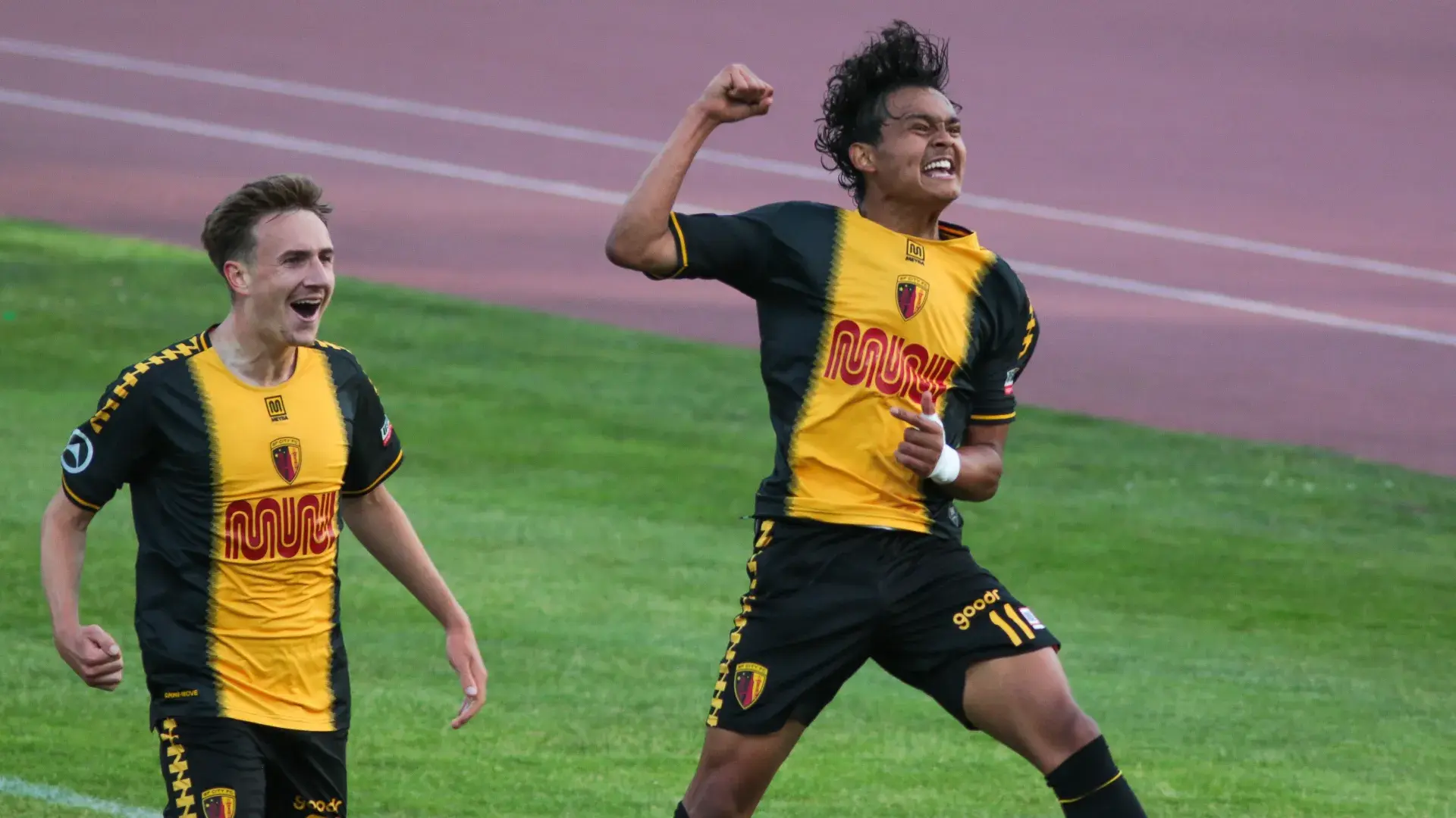 SF City FC players jumping for joy on Kezar Stadium field