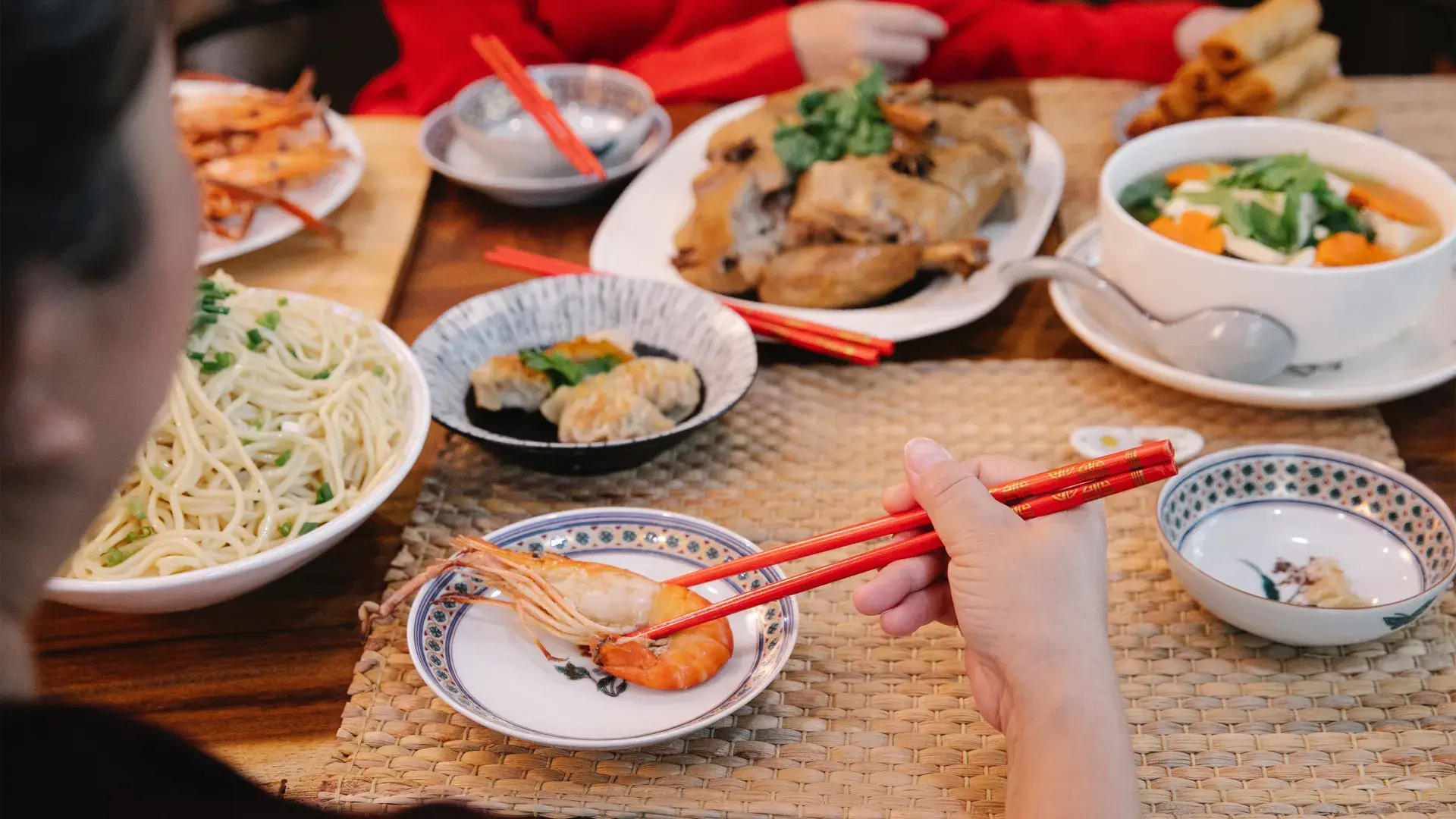Spread of Chinese food in front of diners at a restaurant
