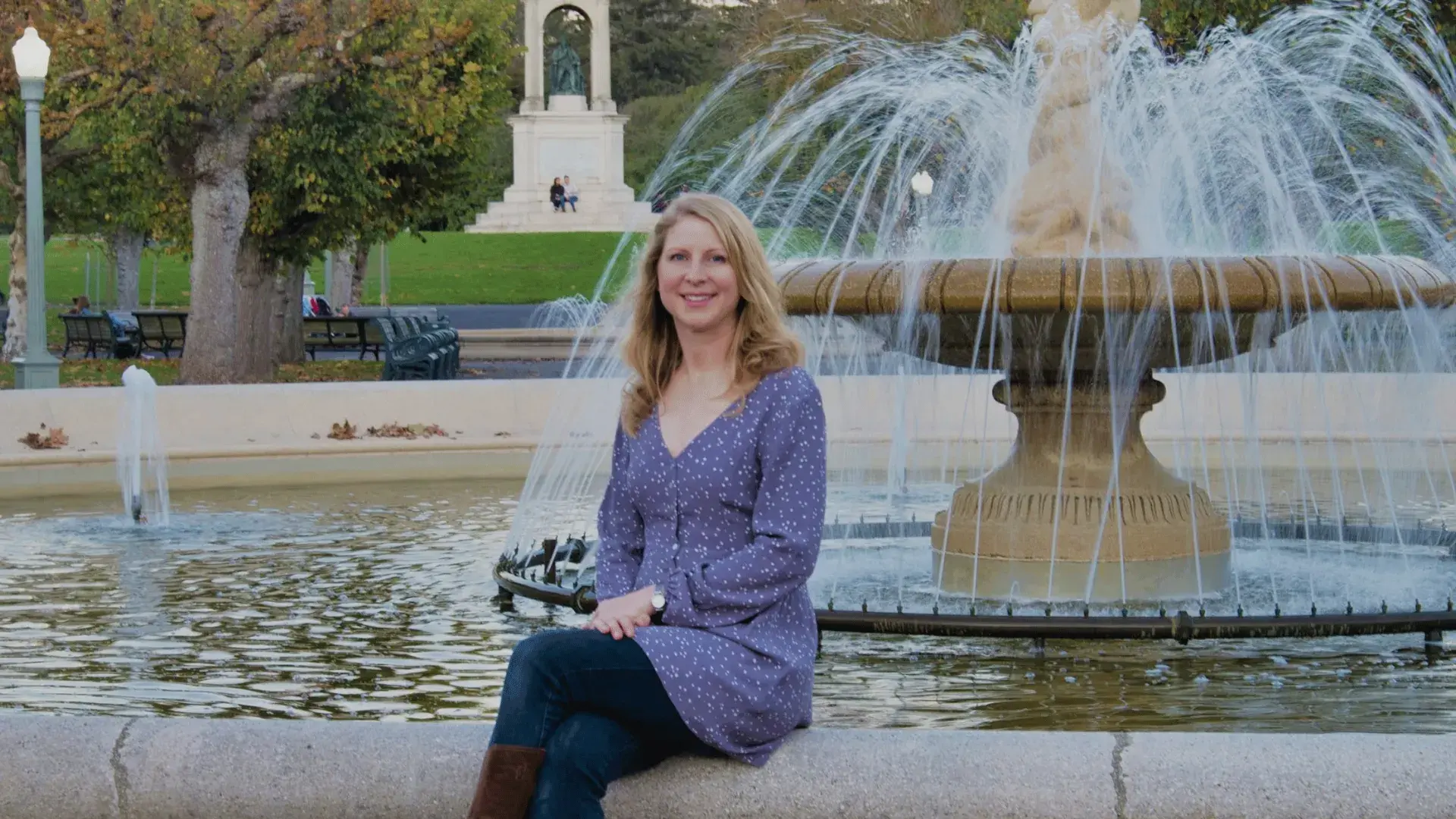 Author Marta Lindsey sits at a fountain in Golden Gate Park's Music Concourse.