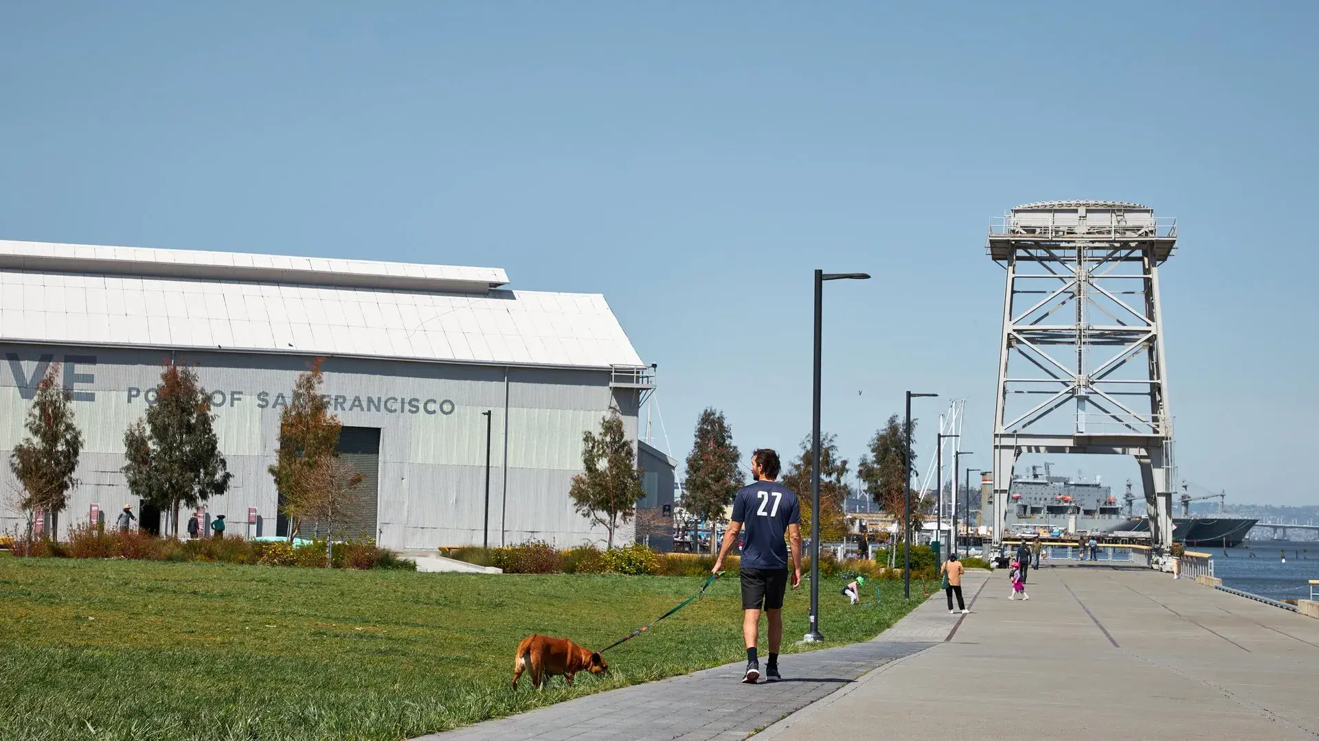 A man walks his dog in Crane Cove Park in San Francisco's Dogpatch neighborhood.