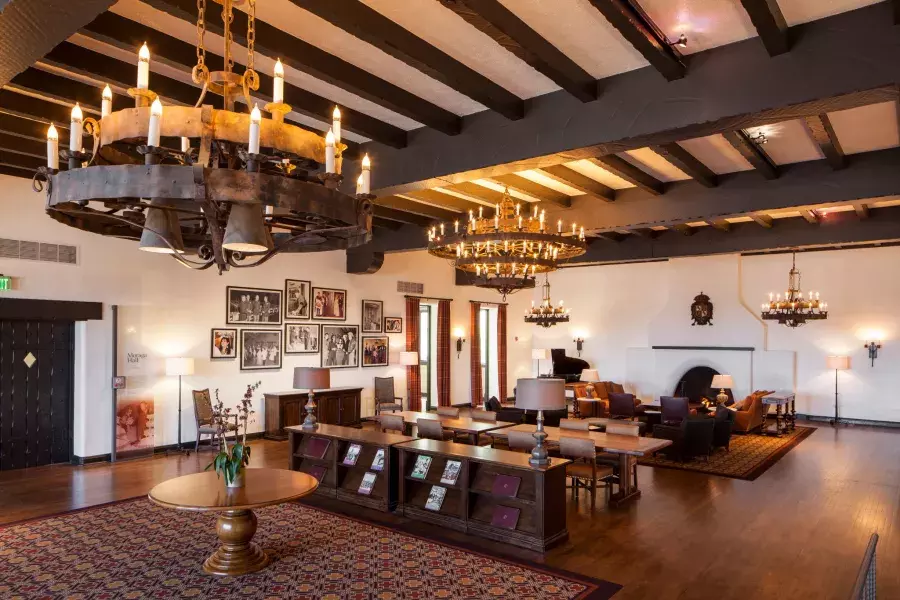 Interior of the historic Presidio Officers' Club, with wood-beam ceilings and large chandeliers.