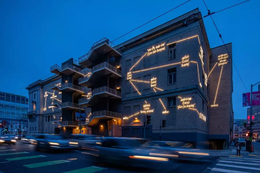 A building in San Francisco is illuminated with light art by artist Joseph Kosuth