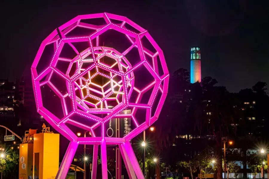 Buckyball glows in the foreground while Coit Tower shines in the distance.