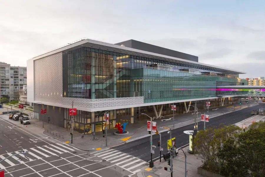 A wide shot of the glassy, modern Moscone Center South building.