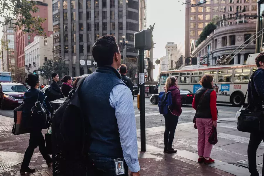 Back of Nick Whittlesey walking in the Financial District.