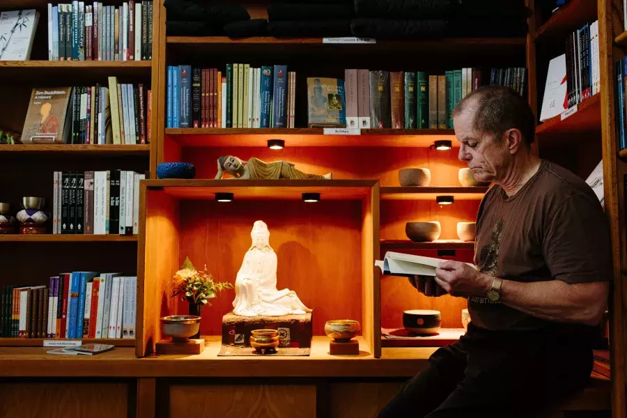 Dennis McNally reading in his office.