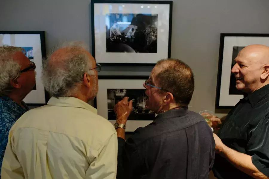 Dennis McNally showing photographs to friends