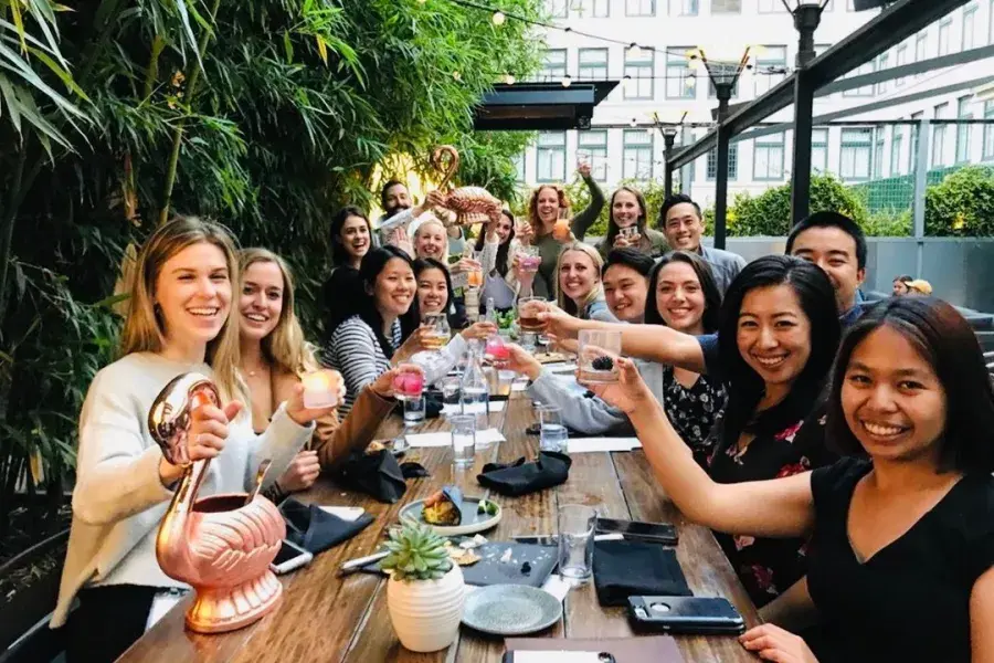 A group of people toasting at Dirty Habit