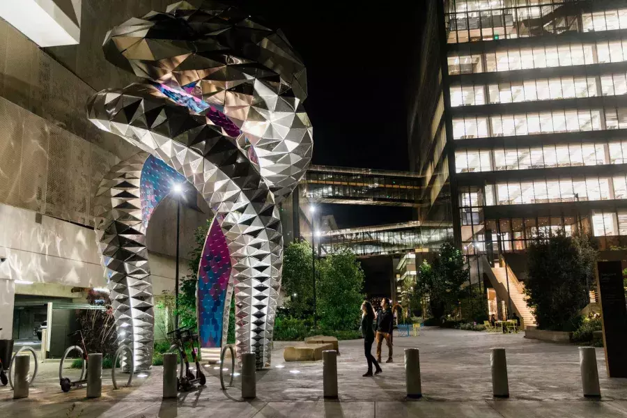 Pedestrians admire a large-scale work of public art, Futureforms, in Mission Bay, California.