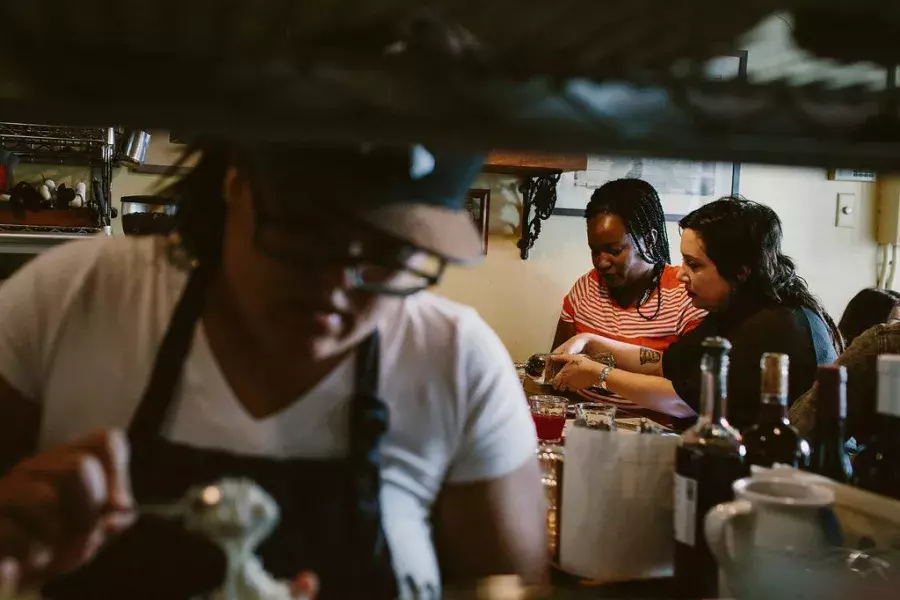 View from the kitchen of diners eating.