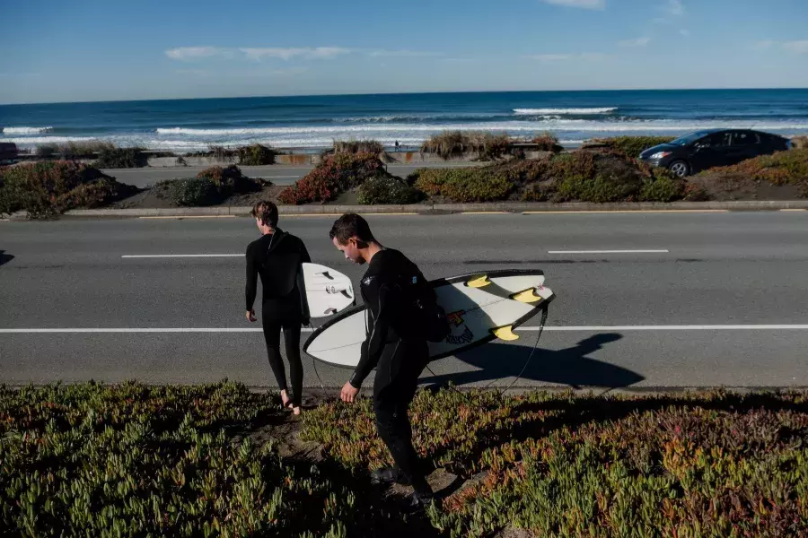 Nick Whittlesey with surfboard heading to Ocean Beach.