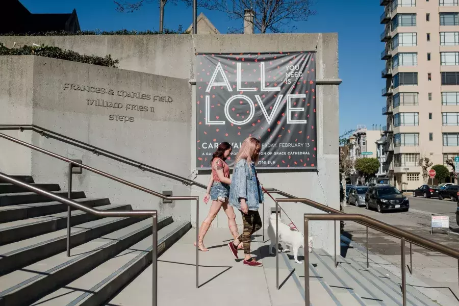 Nya Cruz walking in front of the All is Love sign.