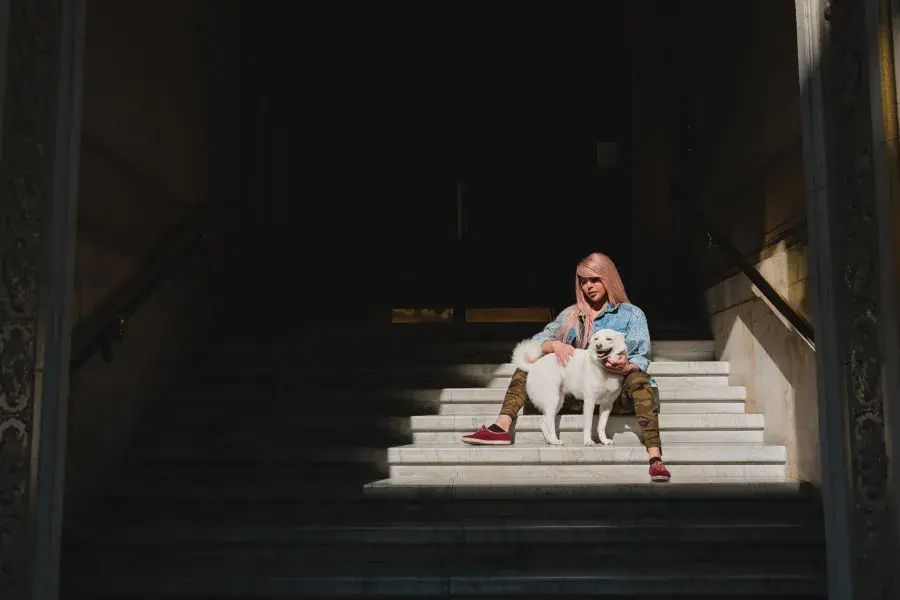 Nya Cruz petting her dog.