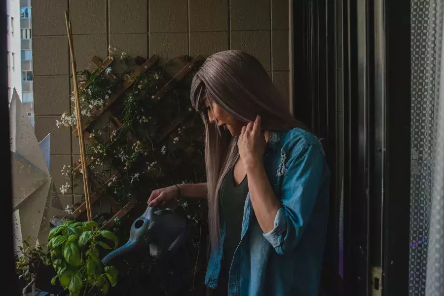 Nya Cruz watering plants.