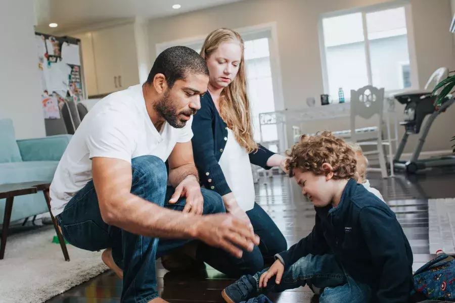 Romulo Melo and his wife playing with their son.