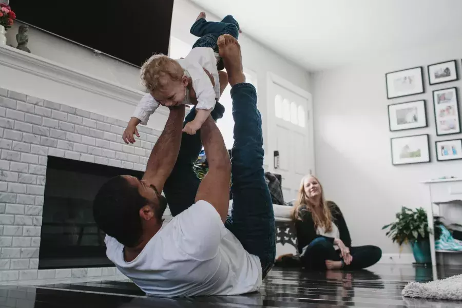 Romulo Melo playing with his son.