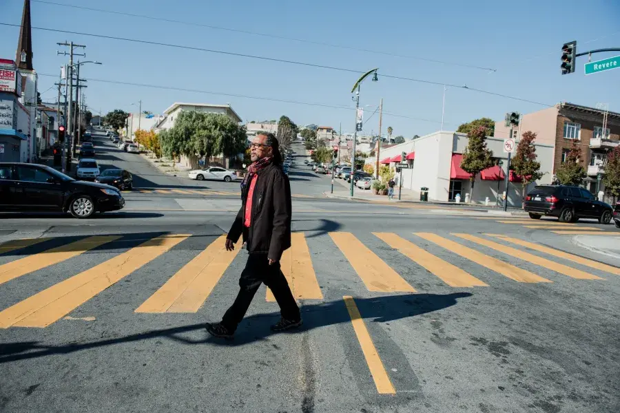Ron Moultrie Saunders walking on the street.