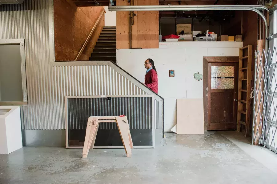 Ron Moultrie Saunders walking up studio stairs.