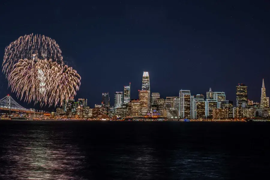 Fireworks explode over the San Francisco city skyline.