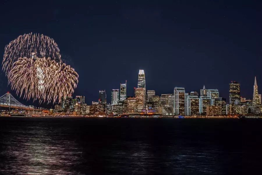 Fireworks explode over the San Francisco city skyline.