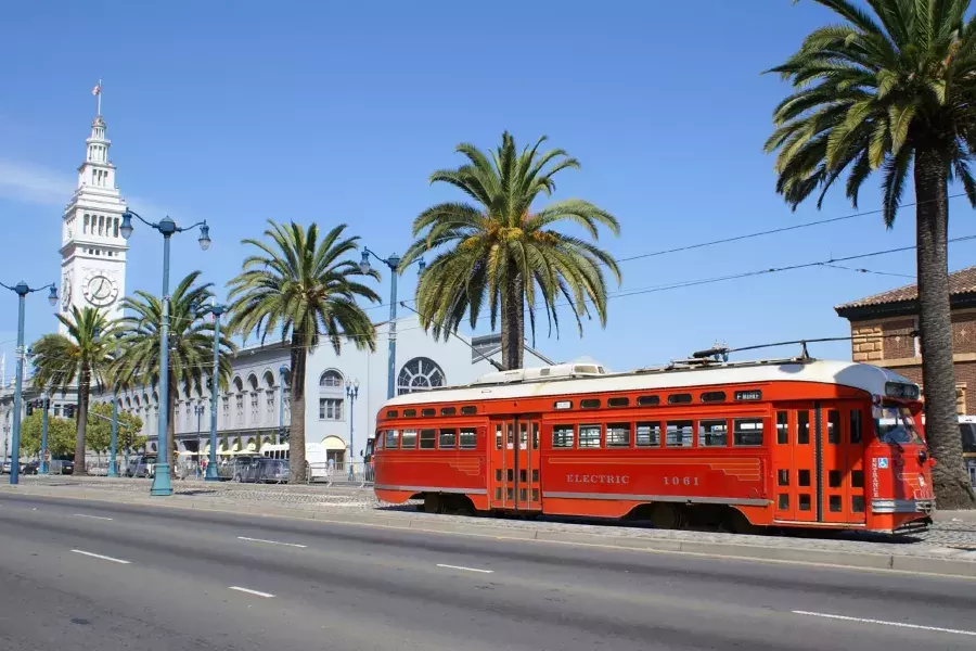 The F Line streetcar rolls down the Embarcadero in front of the Ferry Building.