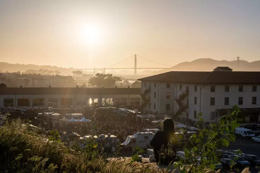 View of Fort Mason and the Golden Gate Bridge at sunset.