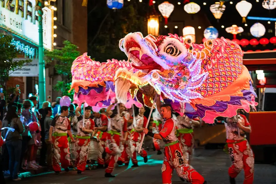 Dancers manipulate a giant, illuminated dragon during San Francisco's Lunar New Year Parade.