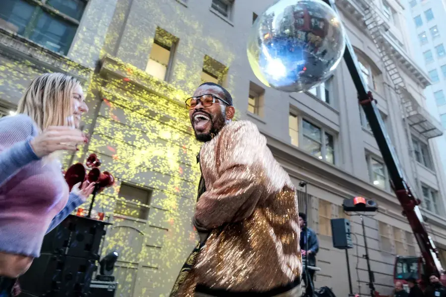 Dancer dancing under a giant disco ball in San Francisco