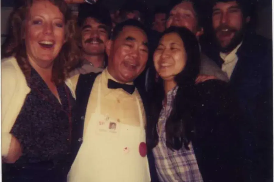 Edsel Ford Fung, the world's rudest waiter, poses at Sam Wo Restaurant with guests.