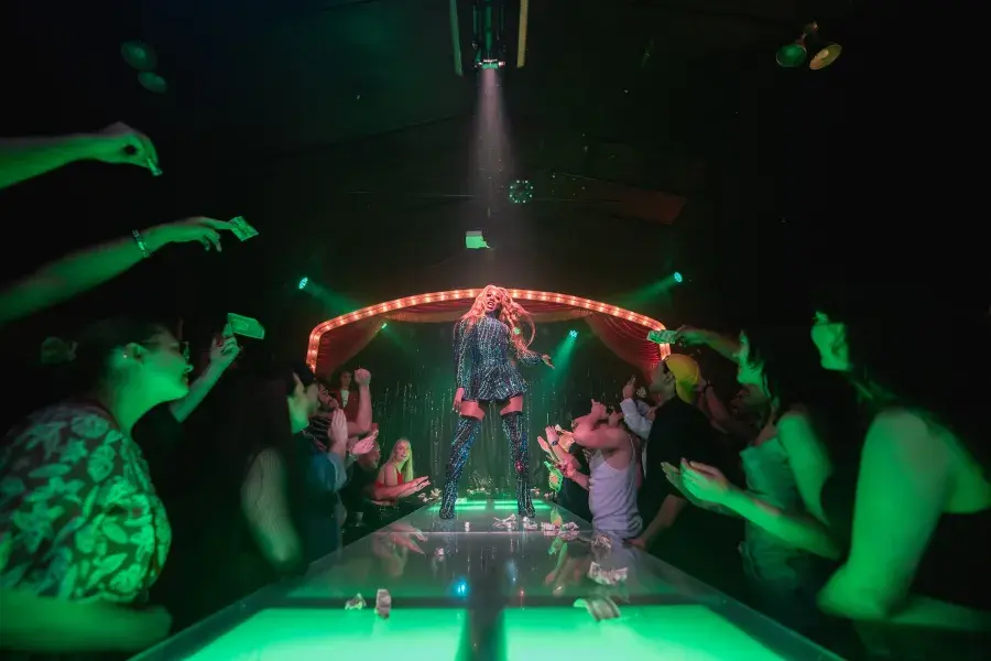 Drag performer dancing for a crowd on the Oasis stage
