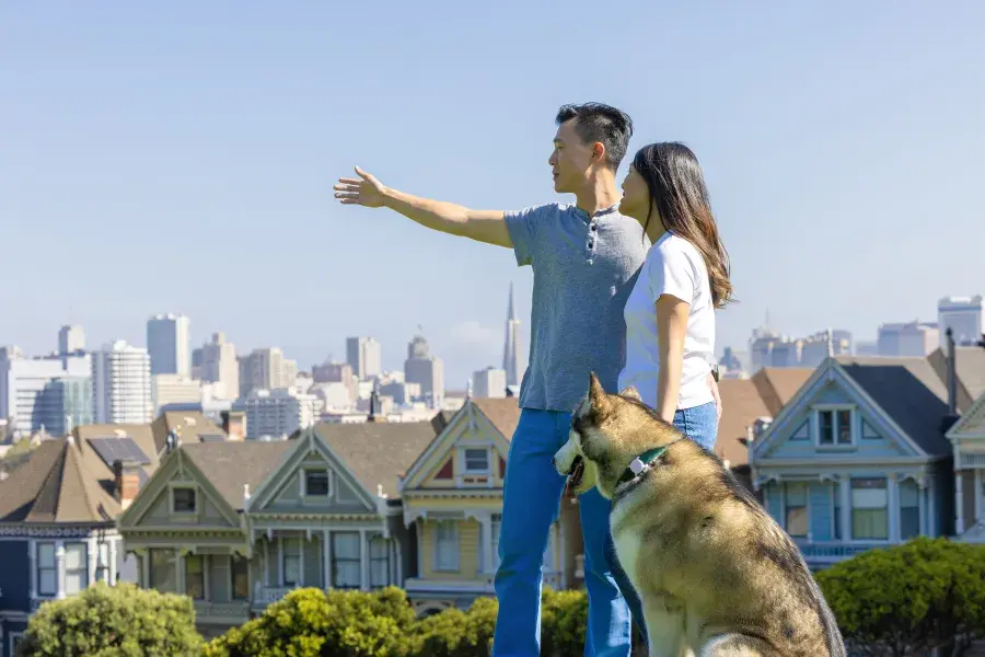 Couple in Alamo Square Park with Husky dog 