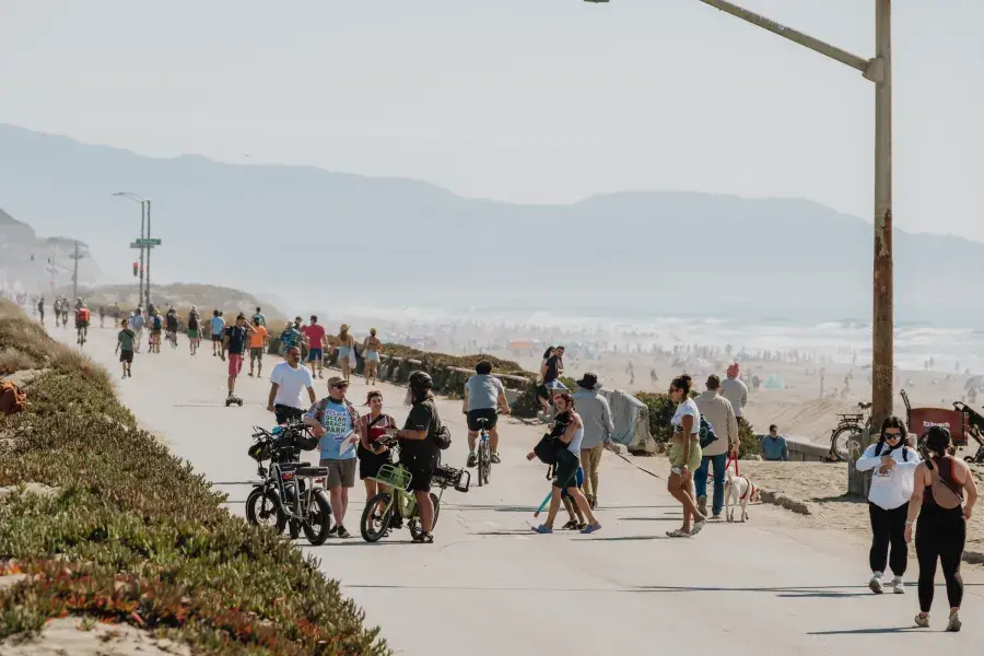 Visitors explore Sunset Dunes on a bright, sunny day.