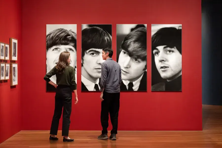 Visitors explore Paul McCartney's photography at the De Young Museum.