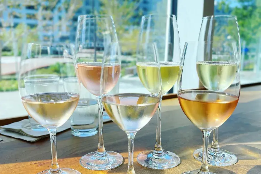Wine glasses on a wooden table by a window