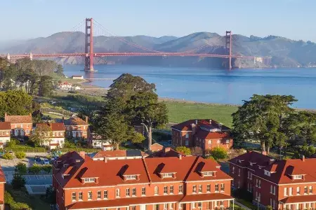 Aerial of the Walt Disney Family Museum with the Golden Gate Bridge in the background