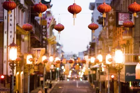 Close-up view of a string of red lanterns hanging above a street in Chinatown. San Francisco, California.