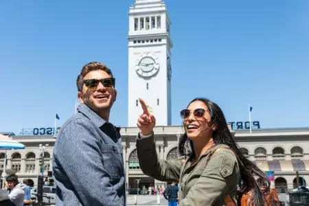 A visiting couple approach the San Francisco Ferry Building.