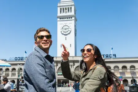 A visiting couple approach the San Francisco Ferry Building.