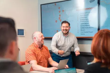 Man facilitating a meeting. He made someone laugh.
